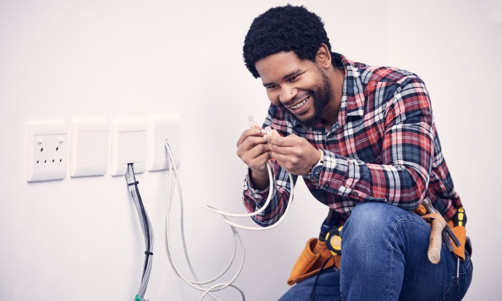 Electric, industry and electrician working on a switchboard with cables for current, fuse or voltag.