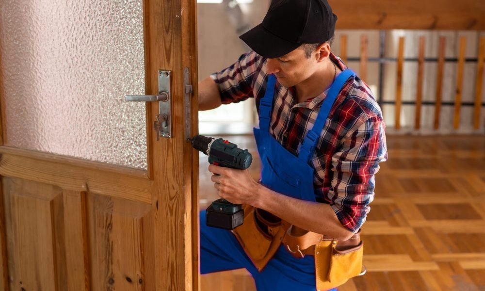 handyman repair the door lock in the room.