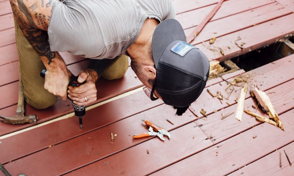 Man repairing wooden decking